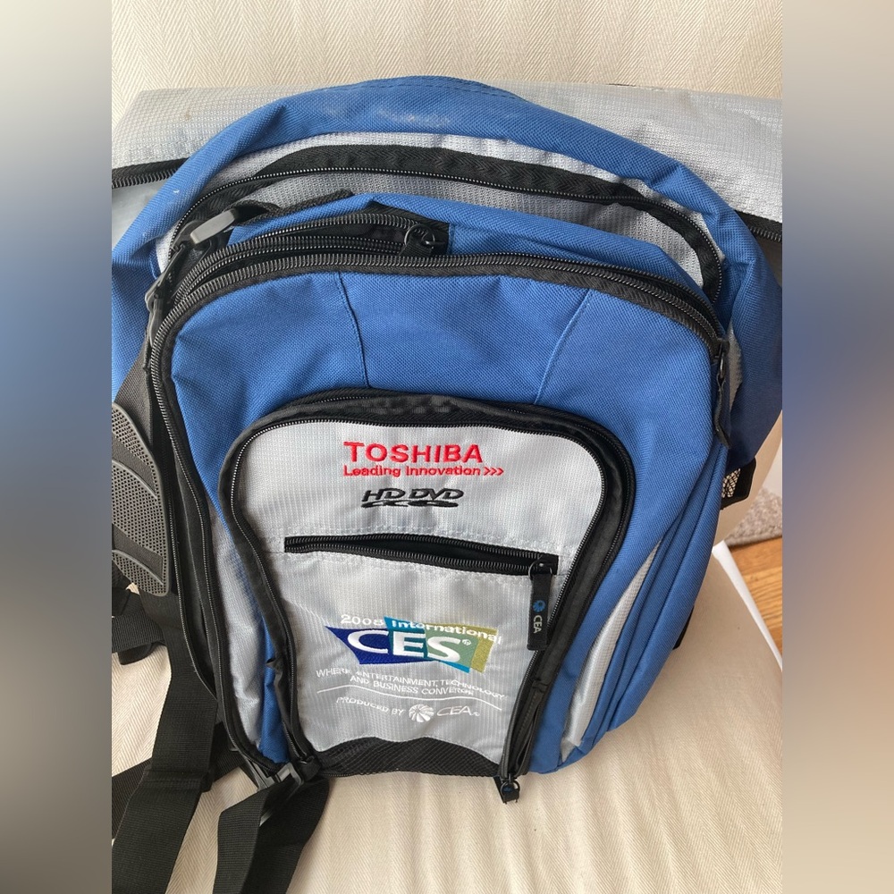 Blue and silver multi-compartment backpack featuring the Toshiba